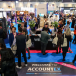 Accountex 2022 welcome desk with people crowded around.