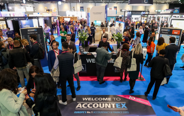 Accountex 2022 welcome desk with people crowded around.